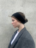 A soft and lightweight unisex headband knitted from alpaka wool .