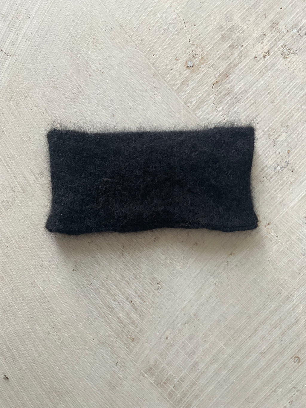 A soft and lightweight unisex headband knitted from alpaka wool .