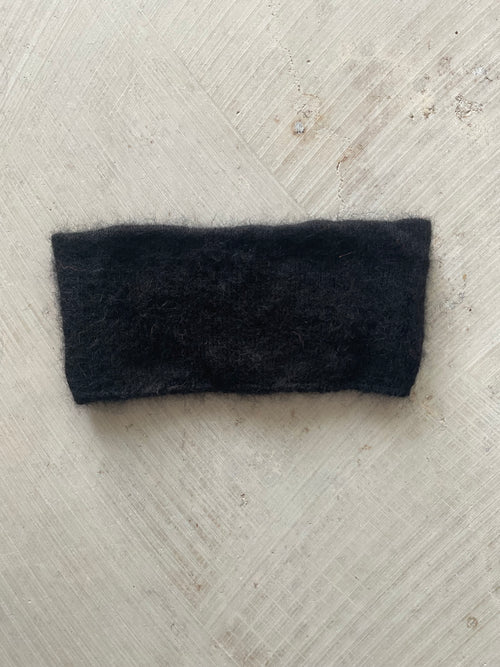 A soft and lightweight unisex headband knitted from alpaka wool .