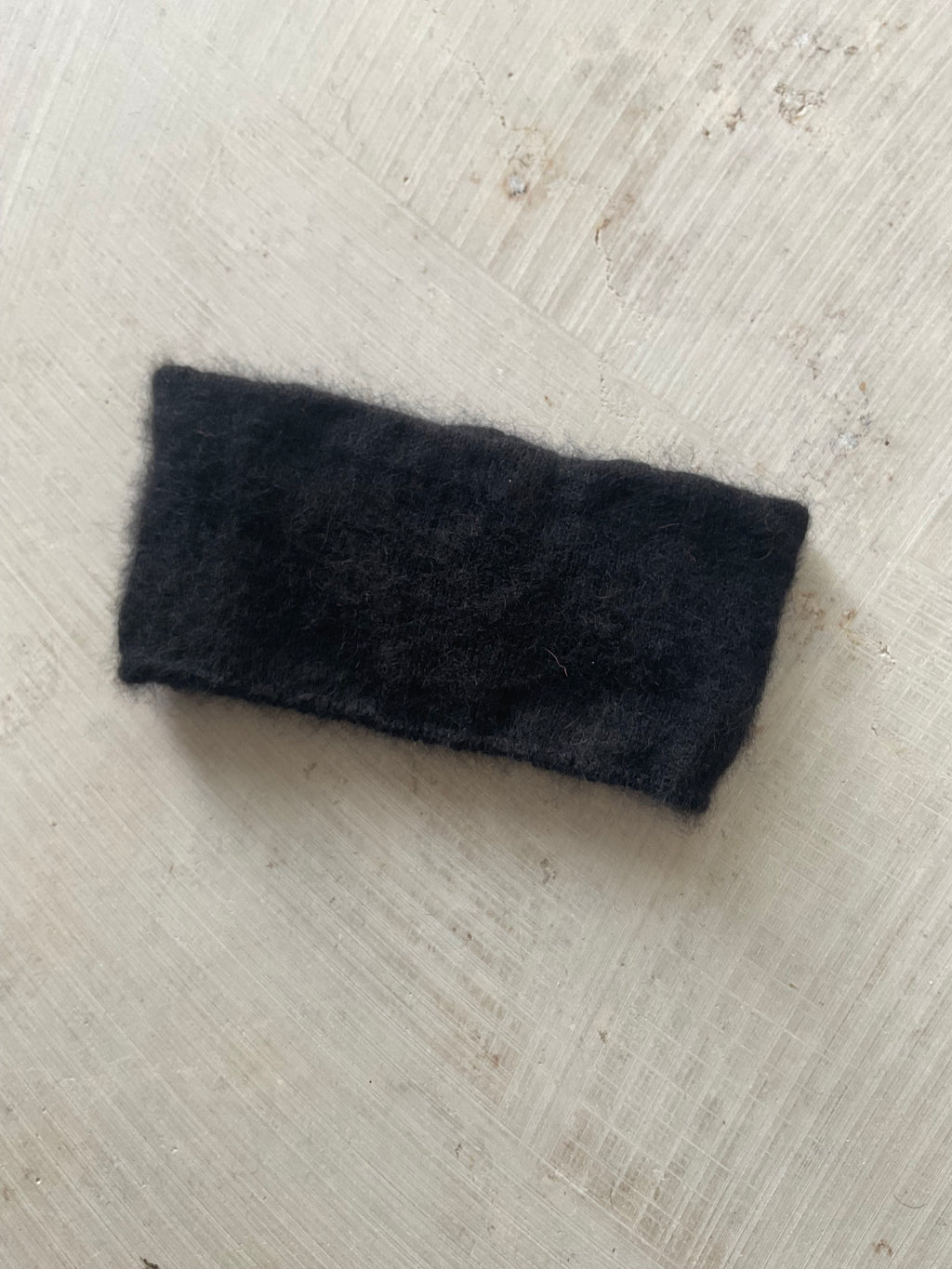 A soft and lightweight unisex headband knitted from alpaka wool .