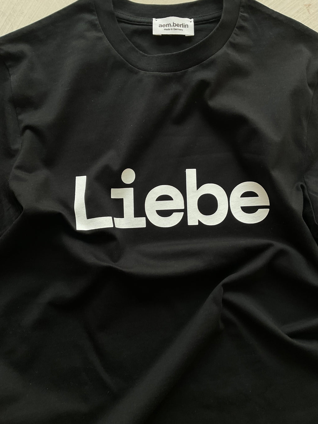 AEM  tshirt LIEBE black with white letters